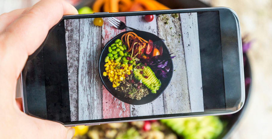 a restaurant owner taking a menu photo using food photography tips from Grubhub