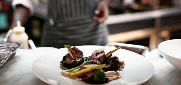 Restaurant owner plating a dish